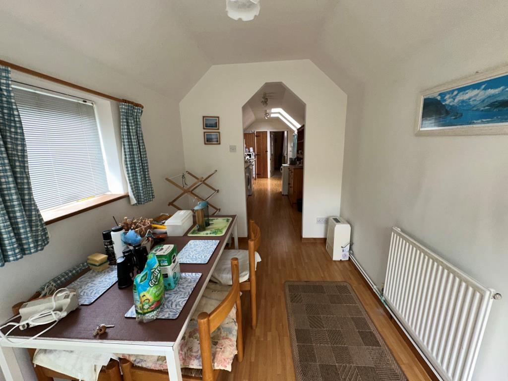 Lot: 74 - SUBSTANTIAL THREE-BEDROOM GARDEN FLAT FOR REFURBISHMENT - Dining Room looking towards the kitchen